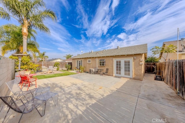 rear view of house with a patio, cooling unit, and french doors