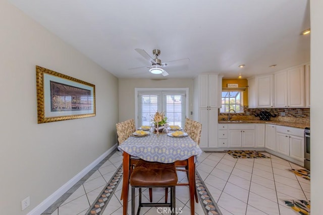 tiled dining area with sink and ceiling fan