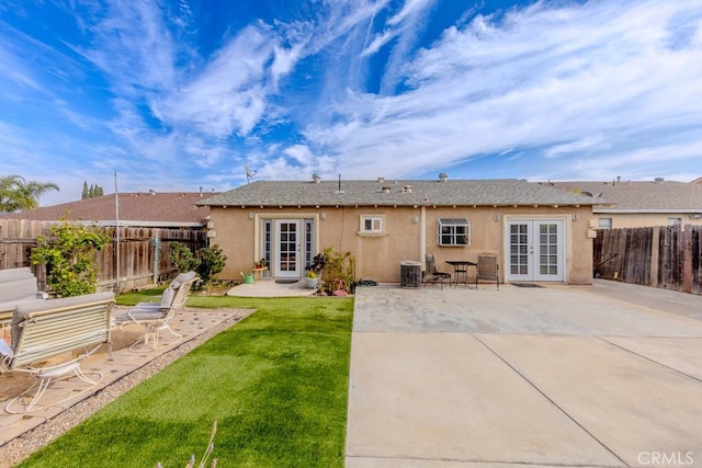 back of house featuring french doors, central AC, a patio, and a lawn