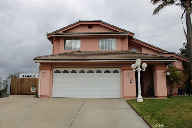 view of front of property featuring a garage and a front lawn