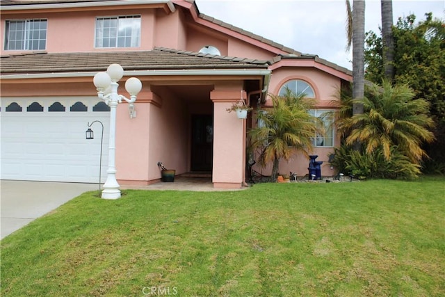 view of front of property with a garage and a front yard