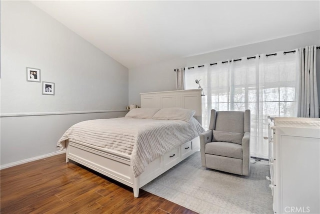 bedroom with lofted ceiling and dark wood-type flooring