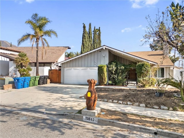 mid-century modern home with a garage and driveway