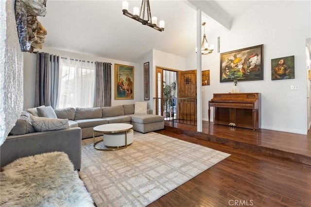 living room featuring hardwood / wood-style flooring, a chandelier, high vaulted ceiling, and beamed ceiling