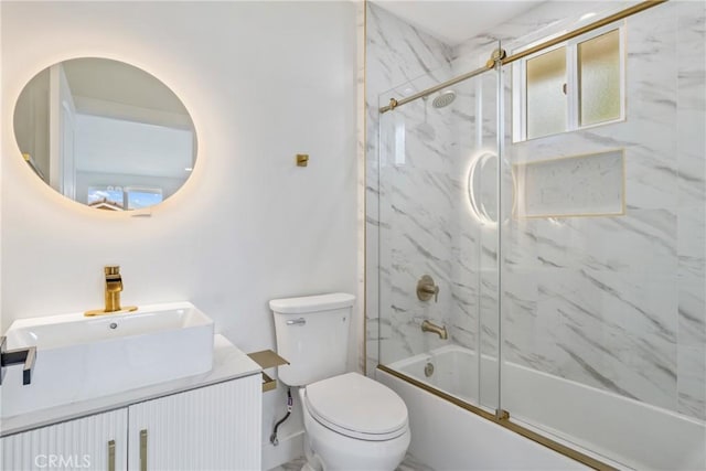 full bathroom with vanity, shower / bath combination with glass door, and toilet