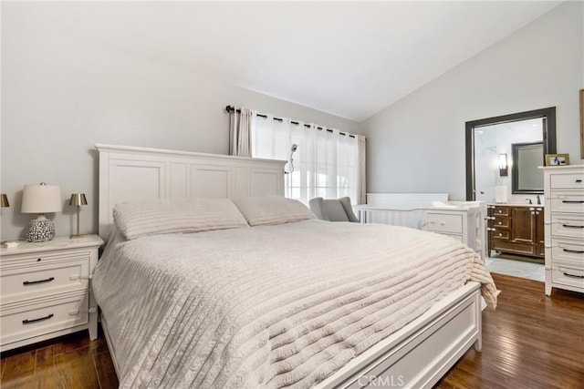 bedroom featuring connected bathroom, dark hardwood / wood-style flooring, and vaulted ceiling