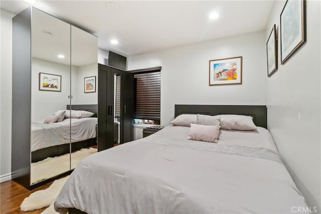 bedroom featuring hardwood / wood-style flooring and a closet