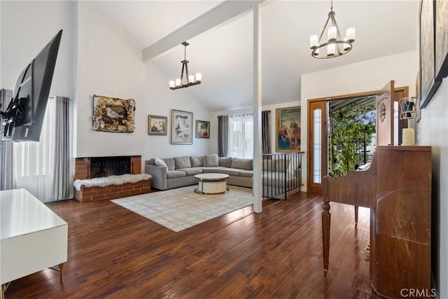 living room with a fireplace, dark hardwood / wood-style floors, a chandelier, and beam ceiling