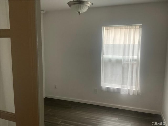 spare room featuring dark hardwood / wood-style flooring