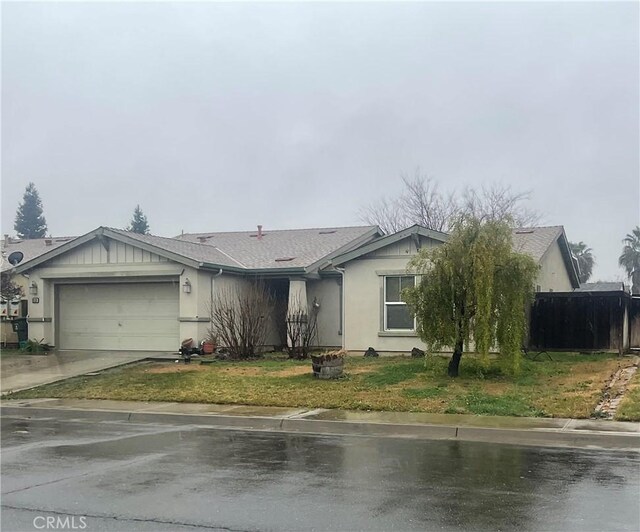 single story home with a garage and a front yard