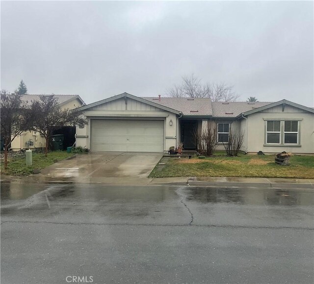 ranch-style house with a garage and a front yard