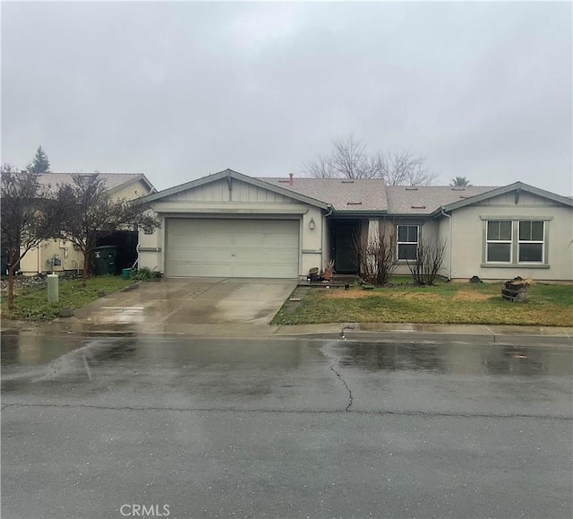 single story home featuring a front yard and a garage