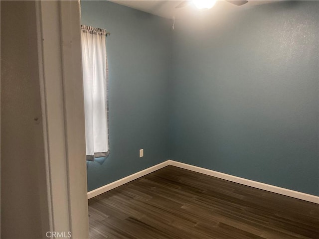 unfurnished room with ceiling fan and dark hardwood / wood-style floors