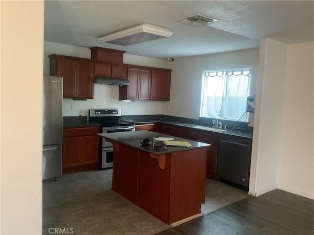 kitchen with sink, a kitchen island, a breakfast bar area, and stainless steel appliances