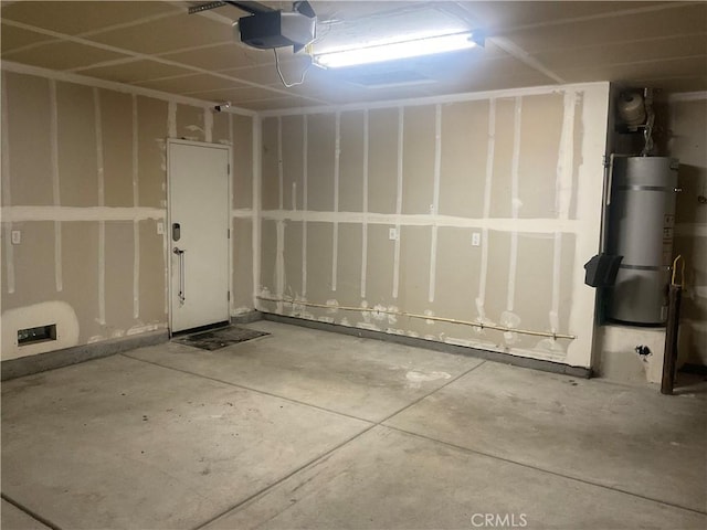 garage with secured water heater and a garage door opener