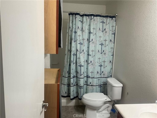 bathroom featuring tile patterned floors, toilet, vanity, and a shower with shower curtain