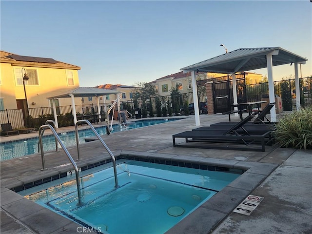 view of pool with a hot tub