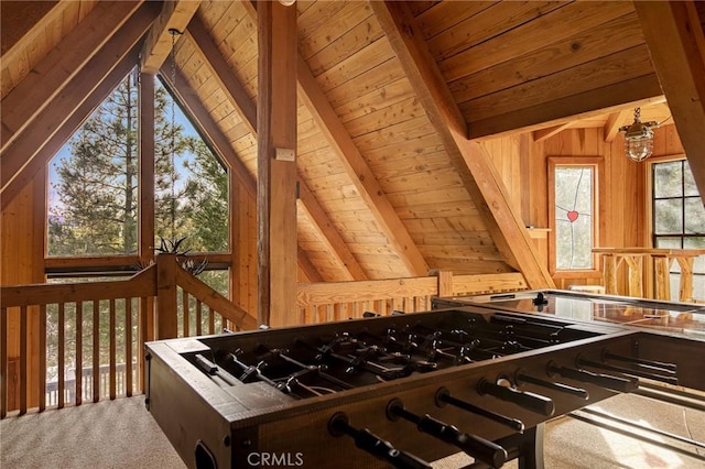 interior space with lofted ceiling with beams, dark brown cabinets, and wood walls