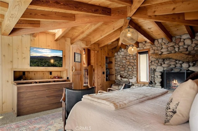 bedroom featuring a fireplace, carpet, and wood walls