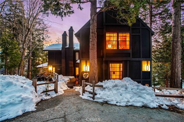 view of snow covered rear of property