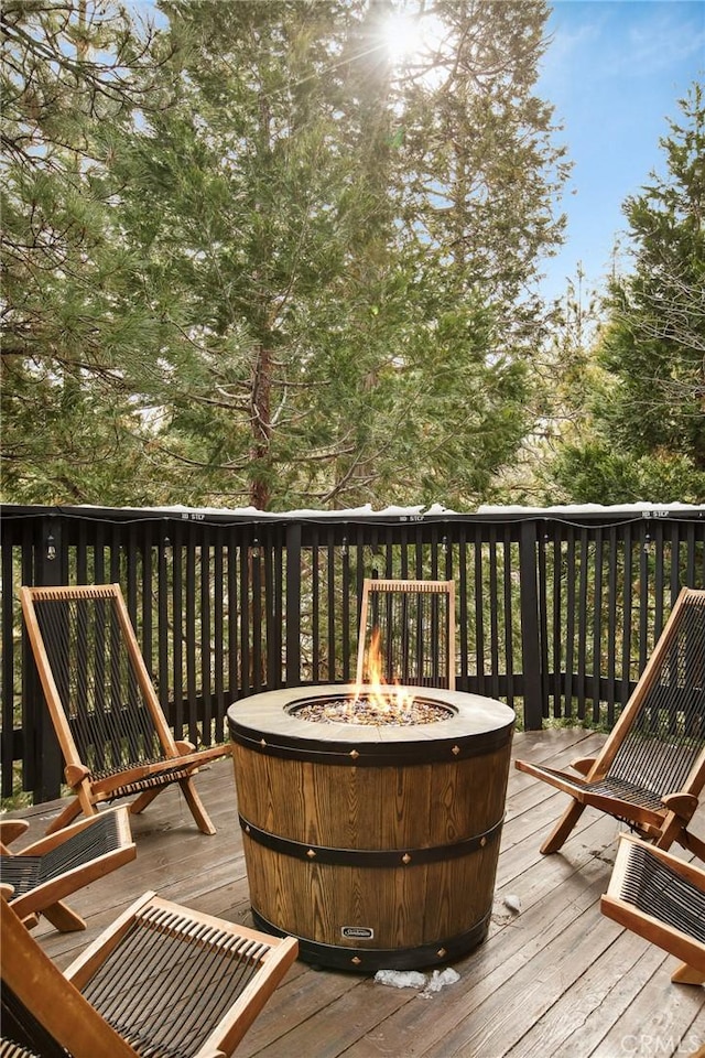 wooden terrace with an outdoor fire pit