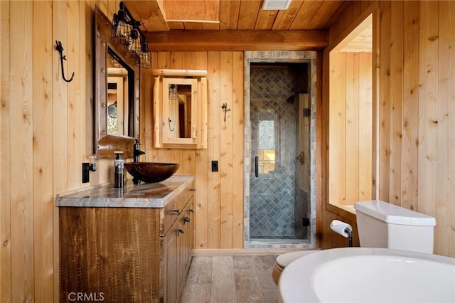 bathroom featuring vanity, hardwood / wood-style floors, wooden ceiling, and wooden walls