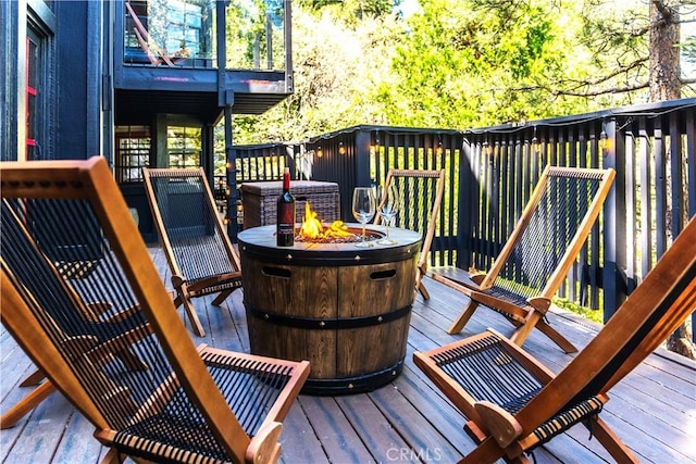 wooden deck with a fire pit