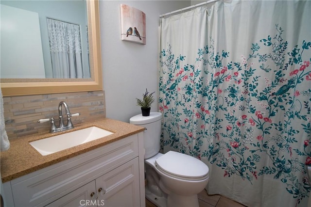 bathroom featuring tile patterned flooring, a shower with shower curtain, vanity, decorative backsplash, and toilet