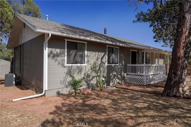 ranch-style house featuring covered porch and central air condition unit