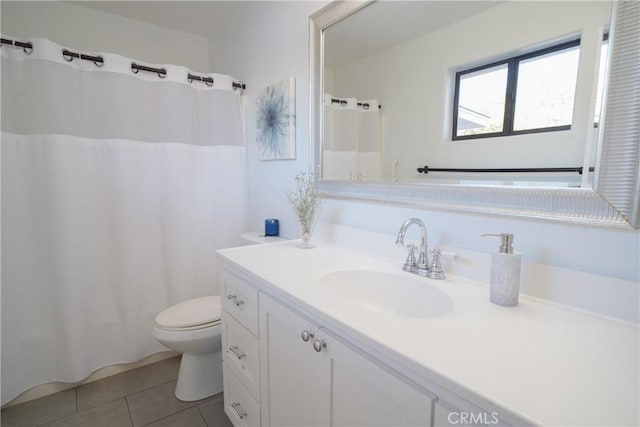 bathroom with vanity, toilet, and tile patterned flooring