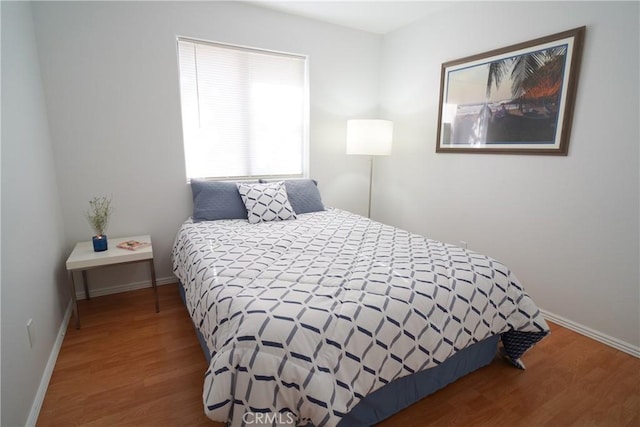 bedroom with hardwood / wood-style flooring