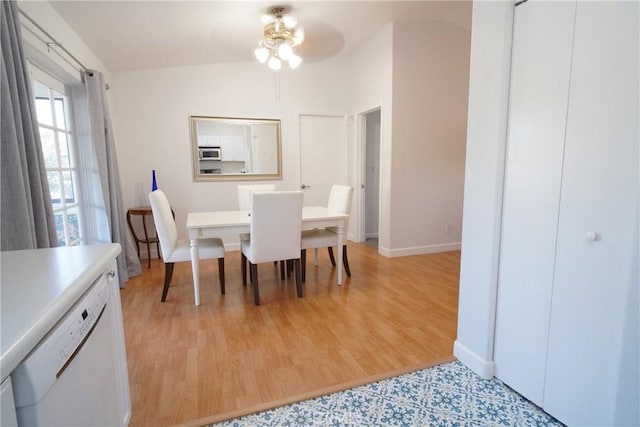 dining space with ceiling fan and light hardwood / wood-style floors