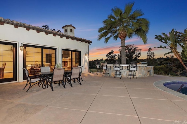 patio terrace at dusk with exterior bar