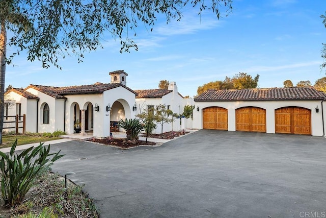 mediterranean / spanish home featuring a garage