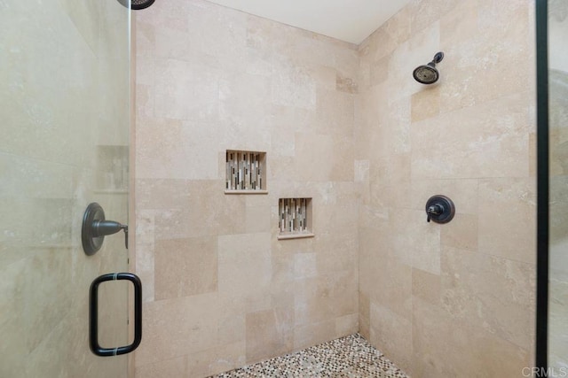 bathroom with a shower with door