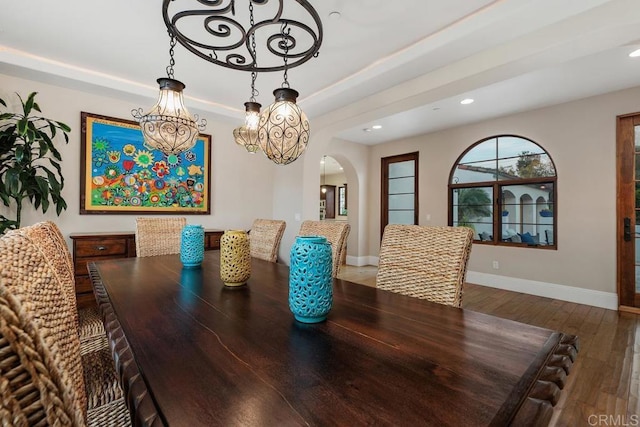 dining space featuring a tray ceiling and hardwood / wood-style flooring