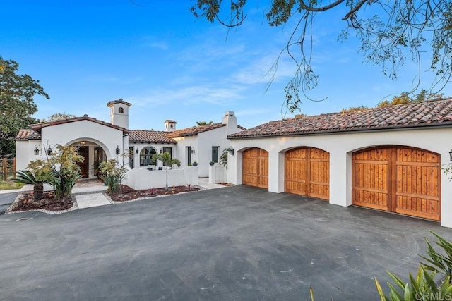 mediterranean / spanish-style house featuring a garage