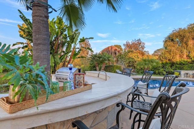 view of patio / terrace featuring a bar, grilling area, and area for grilling