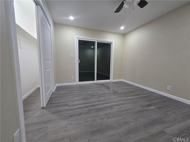 unfurnished room featuring ceiling fan and dark hardwood / wood-style floors