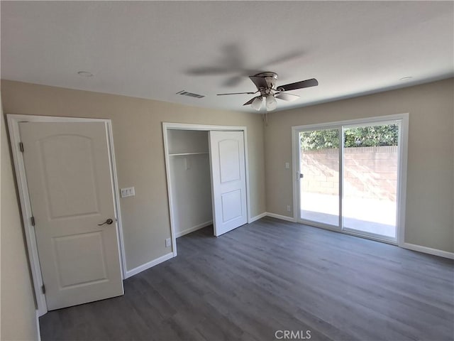 unfurnished bedroom featuring dark hardwood / wood-style floors, ceiling fan, access to exterior, and a closet