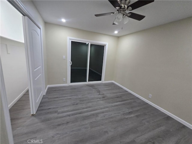 spare room featuring dark wood-type flooring and ceiling fan