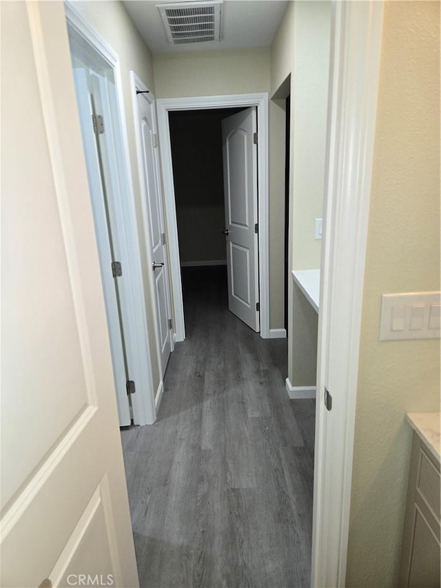 corridor with dark hardwood / wood-style floors