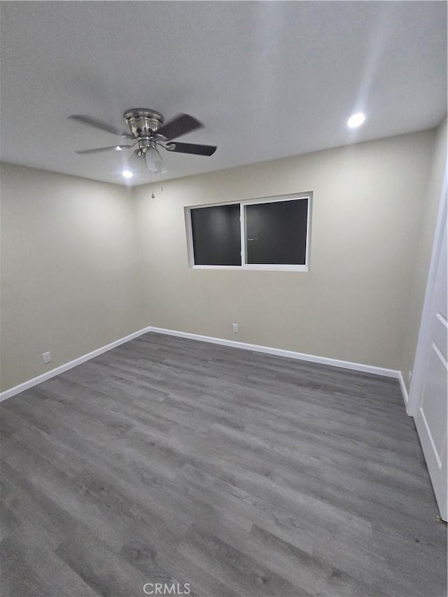 unfurnished room featuring ceiling fan and dark hardwood / wood-style flooring