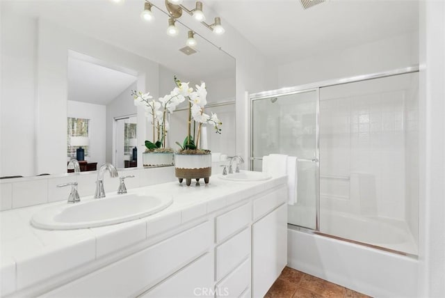 bathroom featuring tile patterned flooring, vanity, vaulted ceiling, and shower / bath combination with glass door