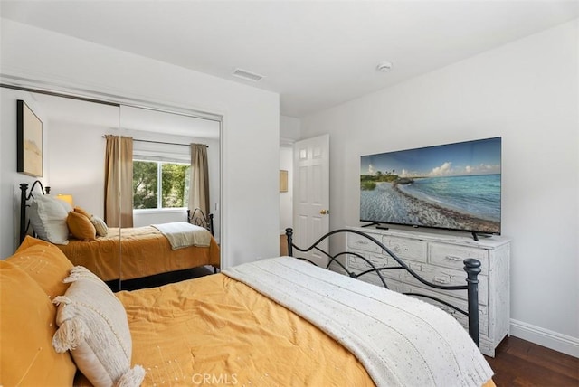 bedroom with dark wood-type flooring