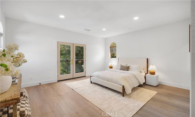 bedroom with french doors and light wood-type flooring