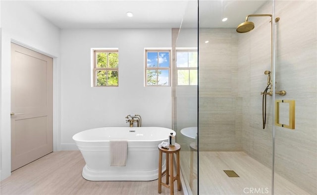 bathroom with wood-type flooring and plus walk in shower