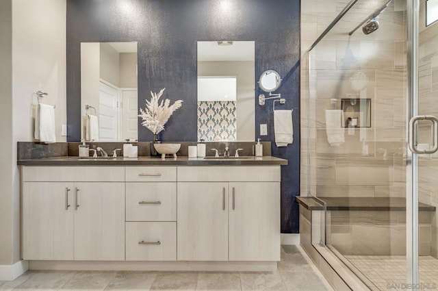 bathroom featuring a shower with door, vanity, and tile patterned flooring