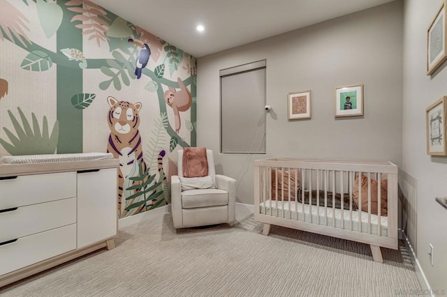 carpeted bedroom featuring a crib