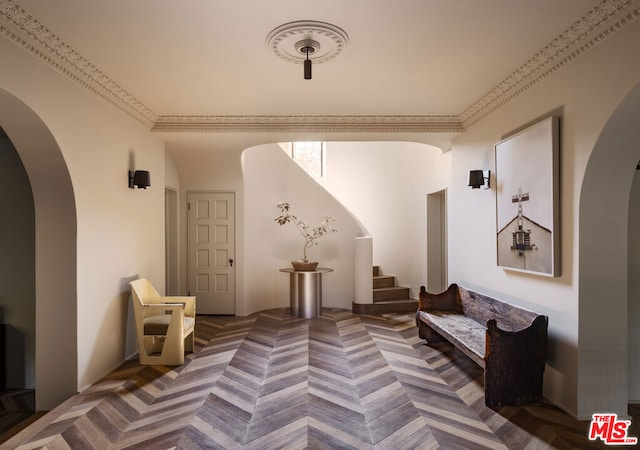 sitting room featuring crown molding and parquet flooring